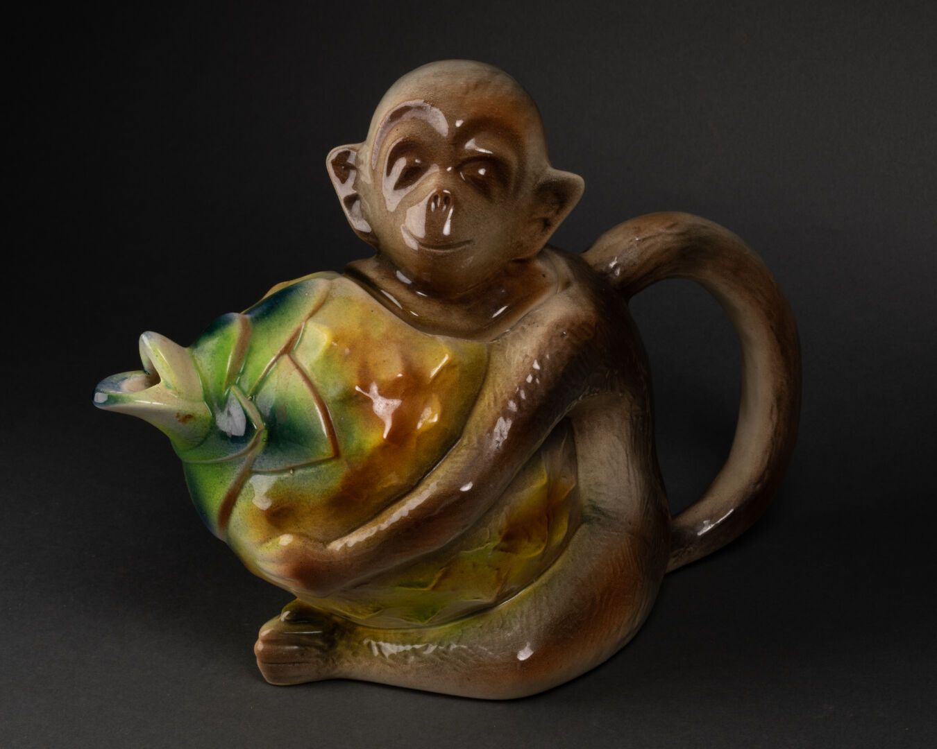 SAINT-CLEMENT France 变形盖浇壶

它的形式是一只猴子拿着一个菠萝，它的头就像一个盖子。

多色釉陶器

底部凹陷的签名

H.20.5厘米