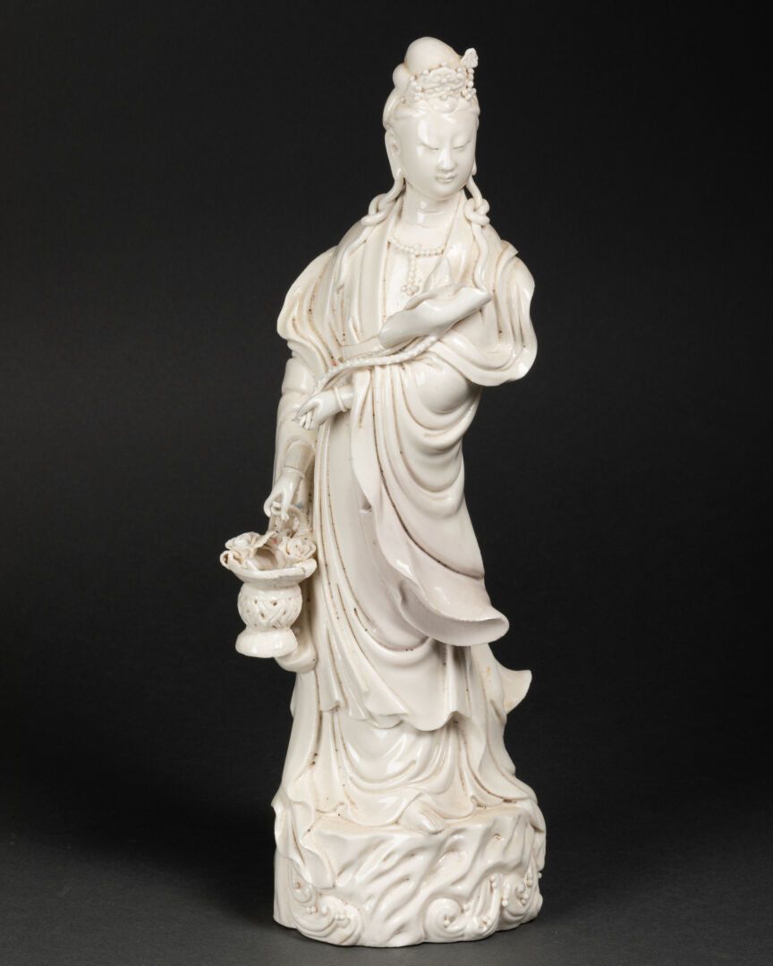 CHINE - Vers 1900 GUANYIN holding a basket in his right hand 

Porcelain known a&hellip;