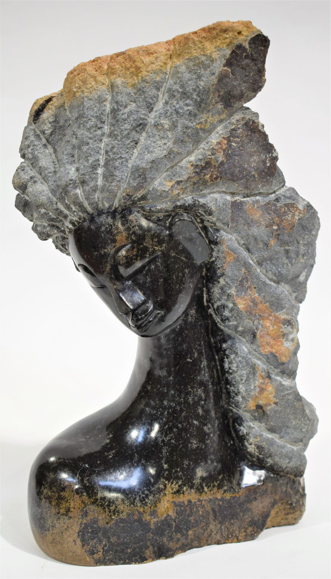 Null Sculpture of a leaning head of a young African woman with flaming hair, rou&hellip;