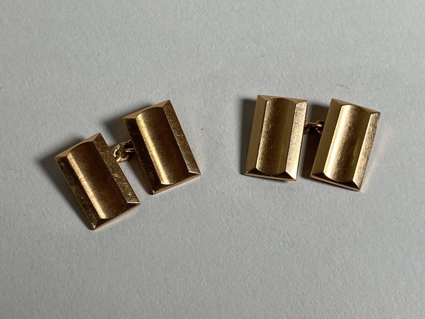 Null 一对18K黄金袖扣，装饰有两个长方形的通道，由一条链子固定。

重量：5.8克。