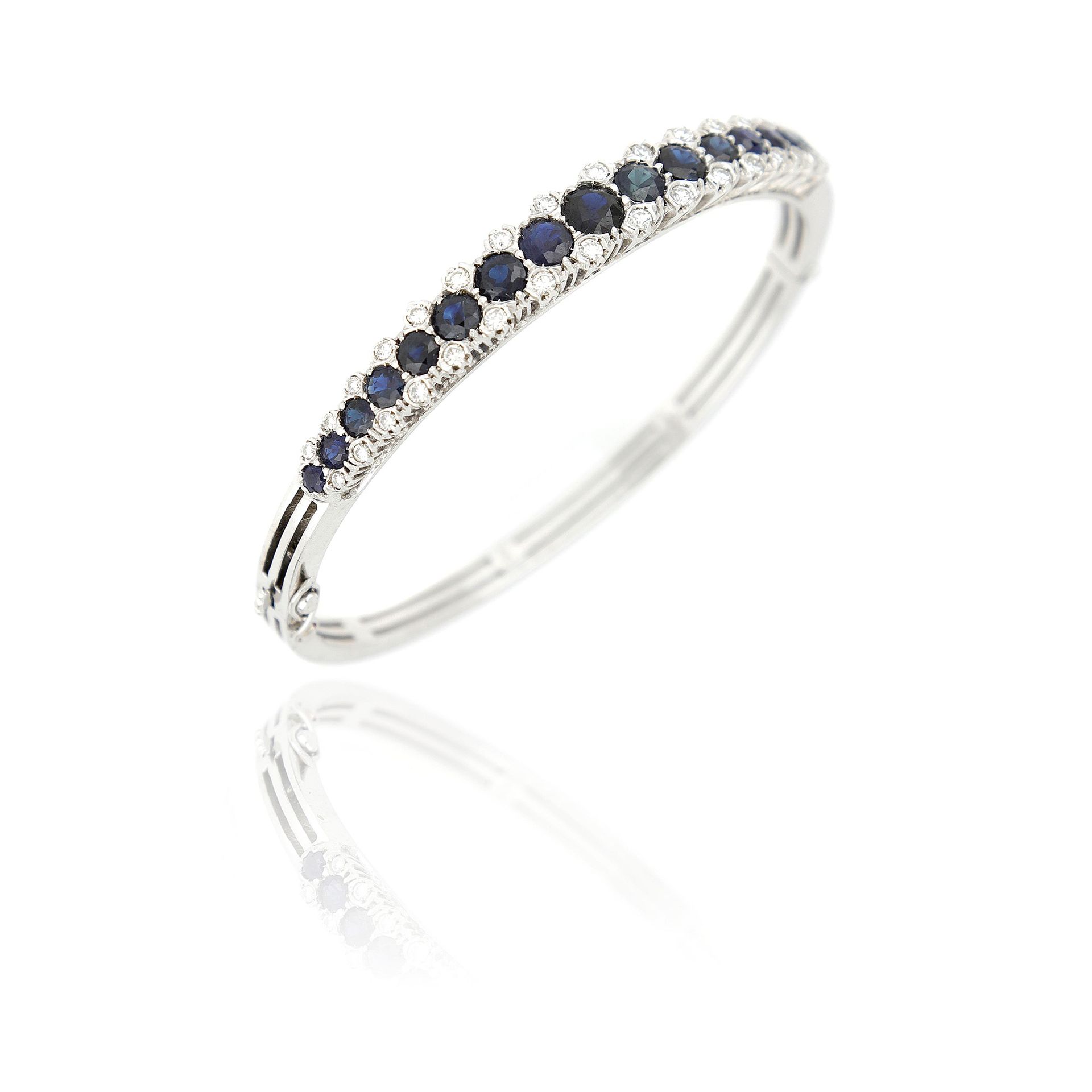 Null 18 Kt white gold rigid bracelet with round sapphires totaling about 4.70 ct&hellip;