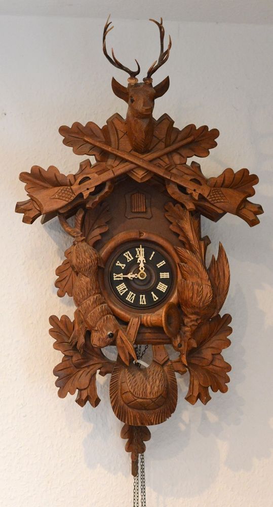 Null Big cuckoo clock, with hunting elements, crowned by a deer head, wood carve&hellip;