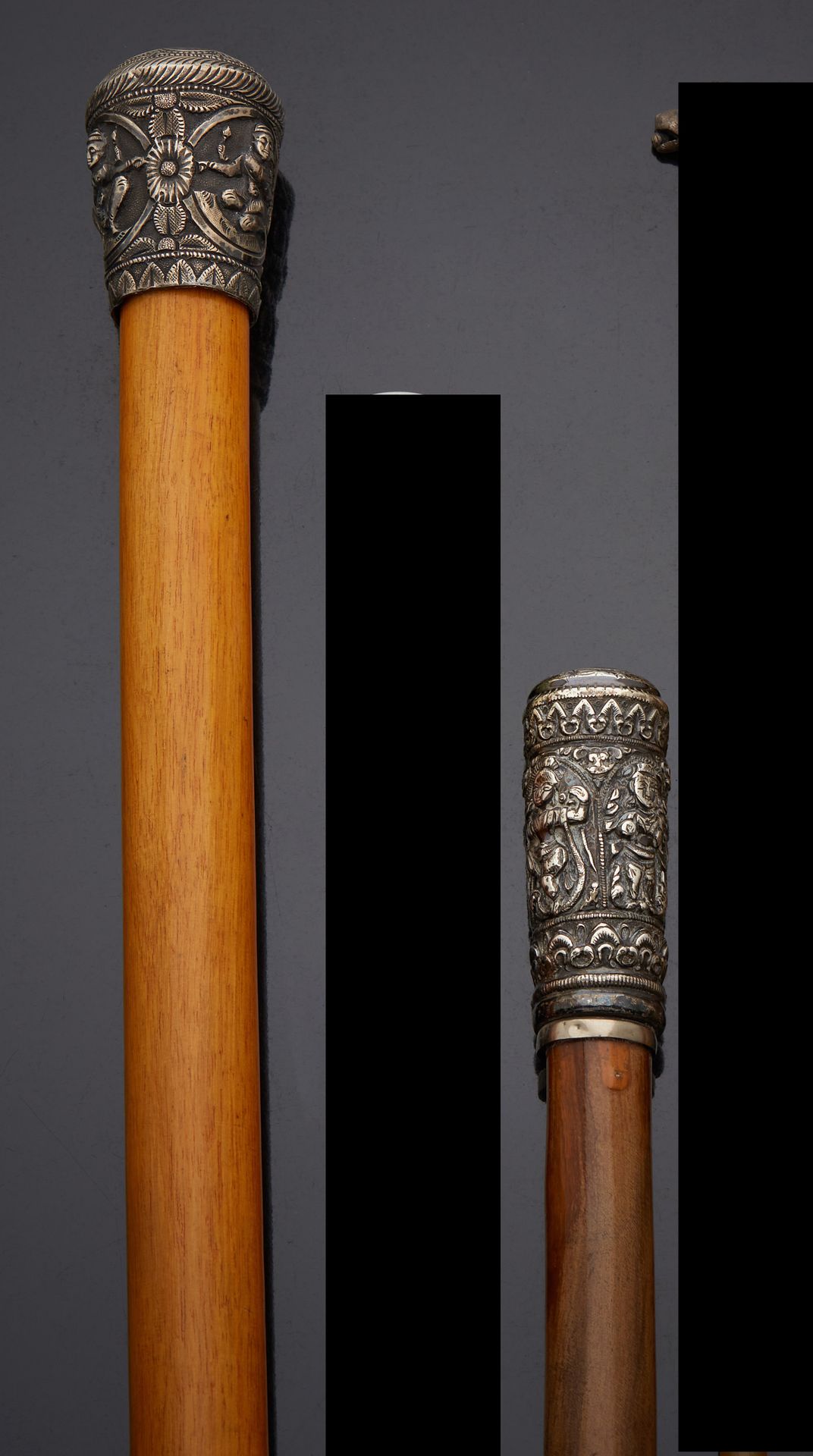 Null Two canes, the knobs decorated with chased divinities