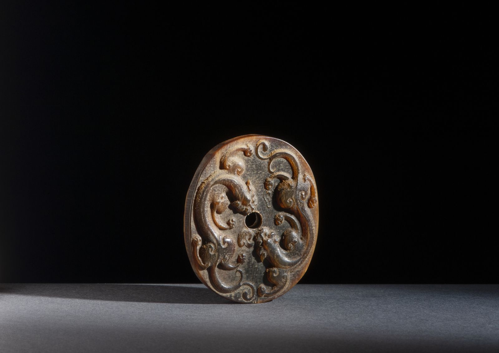 Chinese Art A horn pendant 中国艺术。一个牛角挂件 中国，清朝。椭圆形的挂件，中间有穿孔，雕刻着两个相向的麒麟。厘米5.00 x 6.&hellip;