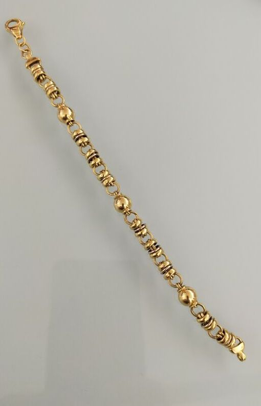 Null 750千分之一黄金铰接式手镯，饰有球和环交替出现。
(穿着)
长度： 18,5 cm 
毛重：14克