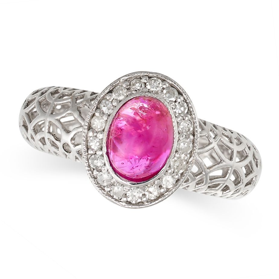 Null A RUBY AND DIAMOND RING in 18ct white gold, set with a cabochon ruby in a b&hellip;