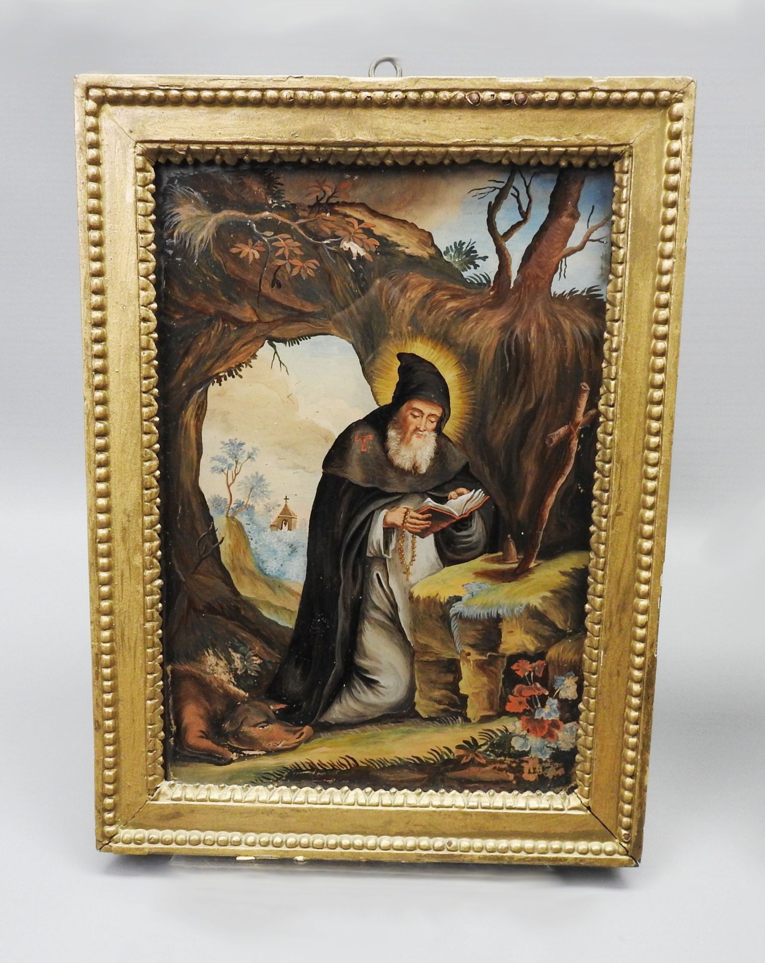 Heiliger Antonius der Große 玻璃上的反画。圣安东尼在这里被描绘成一个隐士，身边躺着乞丐的铃铛和一只猪，而他正在阅读圣经。最小值：F.&hellip;