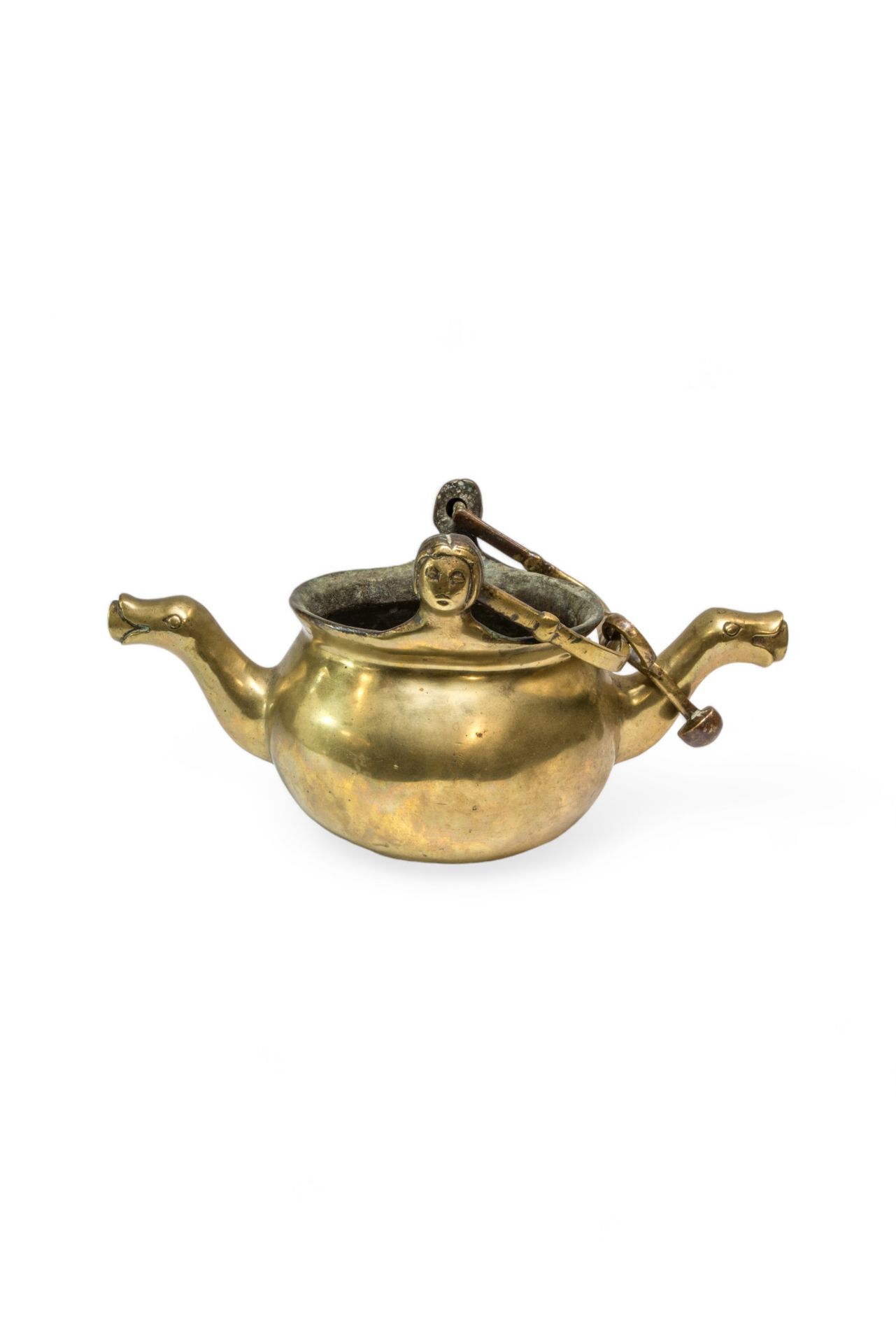 Null 一件铜制 "舀水器 "或盛水器，可能是 17 世纪的作品，两个壶嘴的末端有变形图案，摆动的手柄上有女性头像的耳环。 16 x 31 厘米