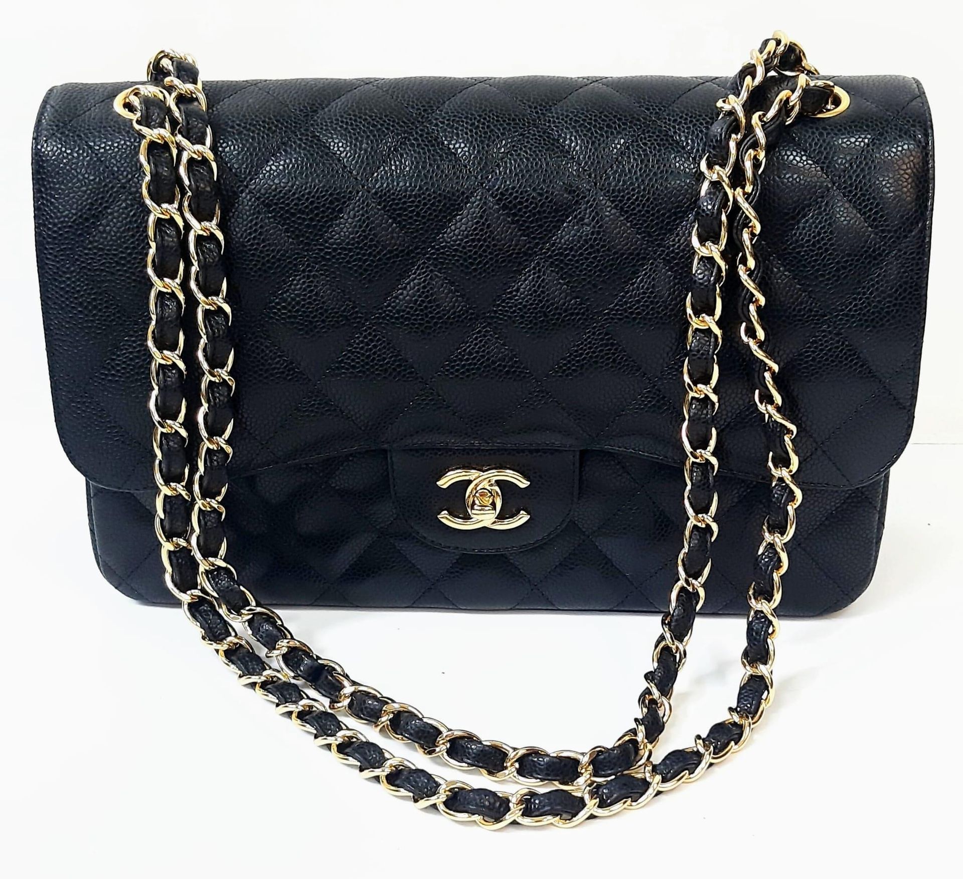 A Classic Chanel Jumbo Flap Bag. Black quilted caviar le…