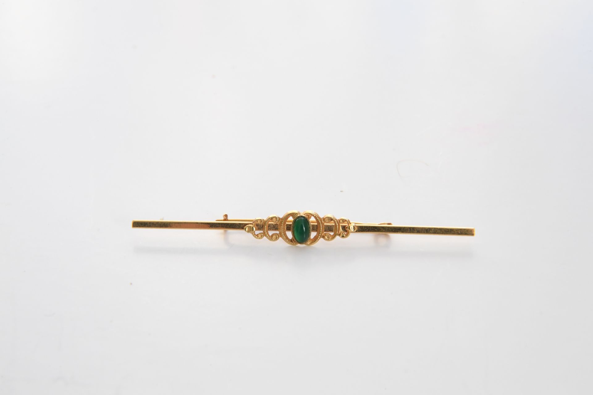 Null Brooch in gold 750°°° with a green stone. Gross weight: 3.3 grams.