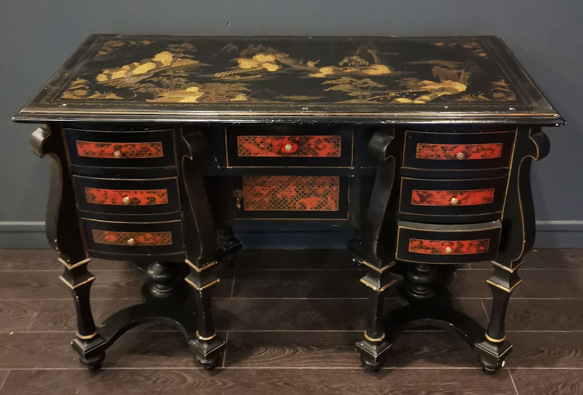 Null A blackened wood Mazarin desk on eight baluster feet joined by a strut, the&hellip;