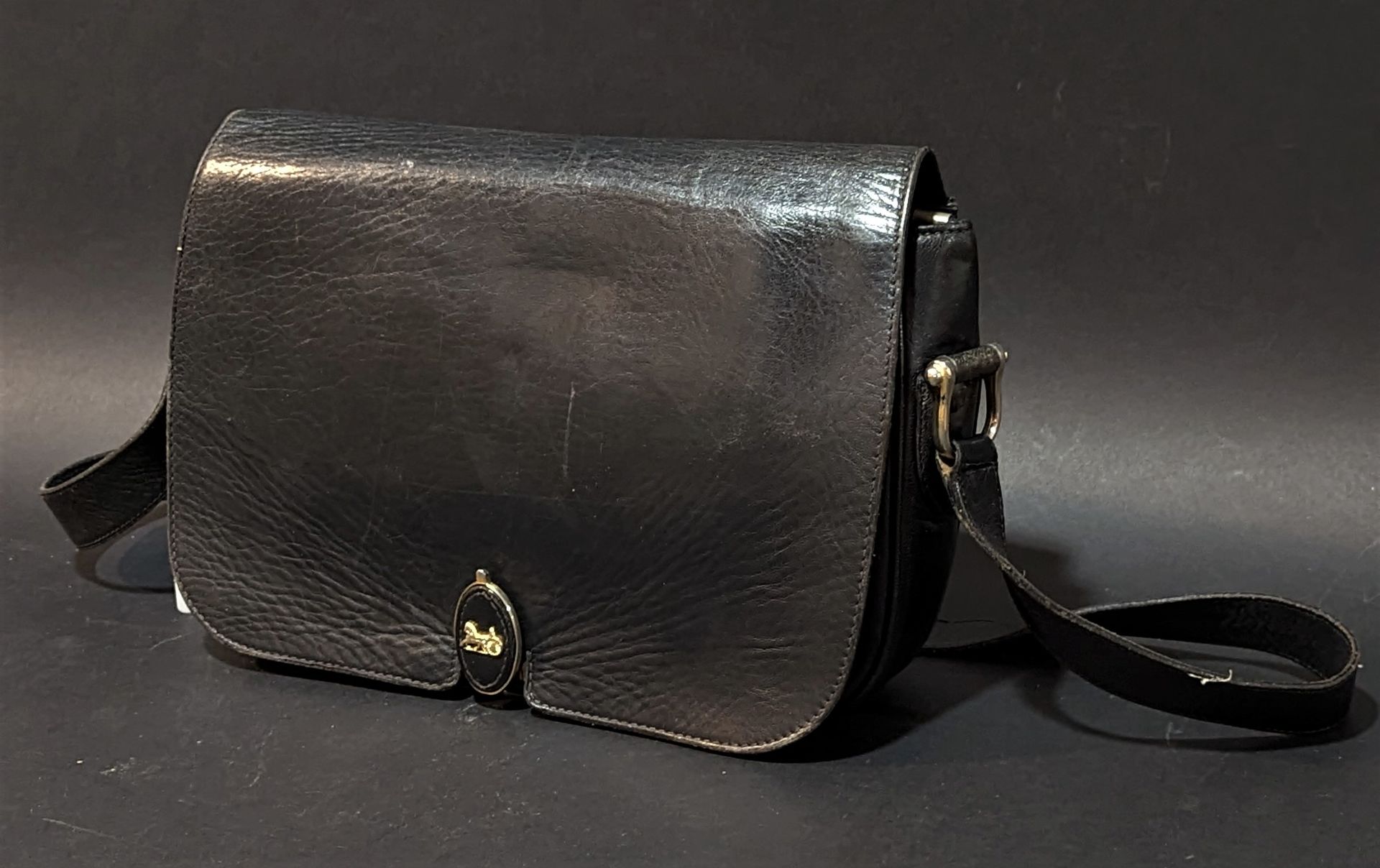 Null CELINE. Black leather bag with flap, shoulder strap. 20 x 29 cm. Rubs, fold&hellip;