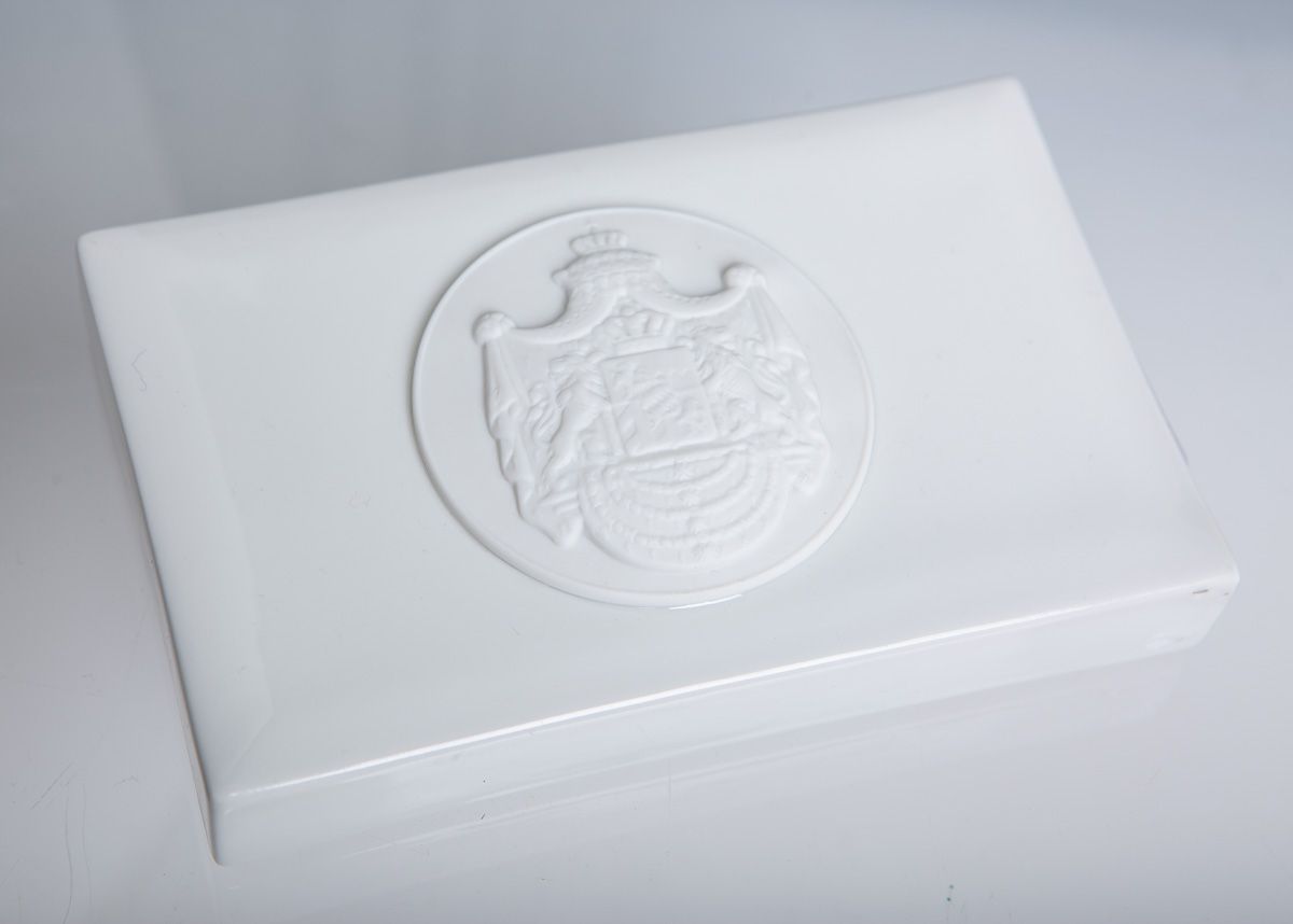 Null 镇纸（宁芬堡），白瓷，带巴伐利亚皇家纹章的无釉圆盘，出版社编号1545a，约2.7 x 14 x 9厘米。正面边缘有生产缺陷（吹釉）。