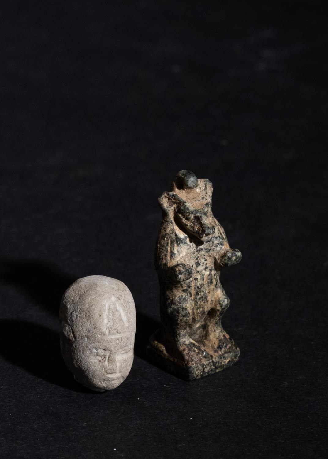 AN EGYPTIAN CLAY HEAD FIGURE OF A PHAROH & A CARVED GRANITE AMULET OF A GOD FIGU&hellip;