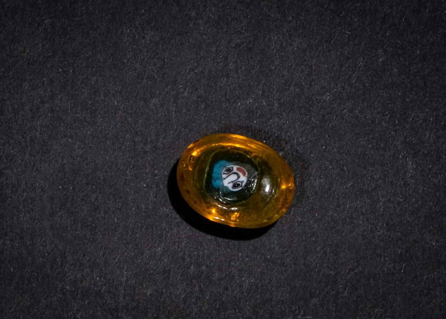 AN AMBER COLOURED GLASS PHOENICIAN FACE BEAD 5TH-4TH CENTURY B.C. PERLE POUR VIS&hellip;