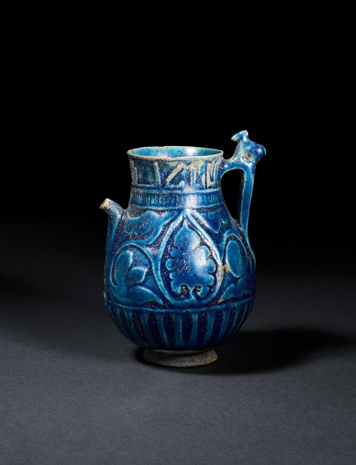 A RARE KUFIC INSCRIBED SELJUK MONOCHROME MOULDED POTTERY JUG, 12TH CENTURY, PERS&hellip;