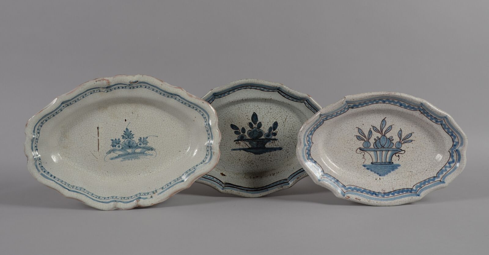 Null 北方
一套三个椭圆形的陶器，棕色底，蓝色单色装饰的花篮。
19世纪
长度32、32.5、37.5厘米
BE，一个有小的珐琅质碎片