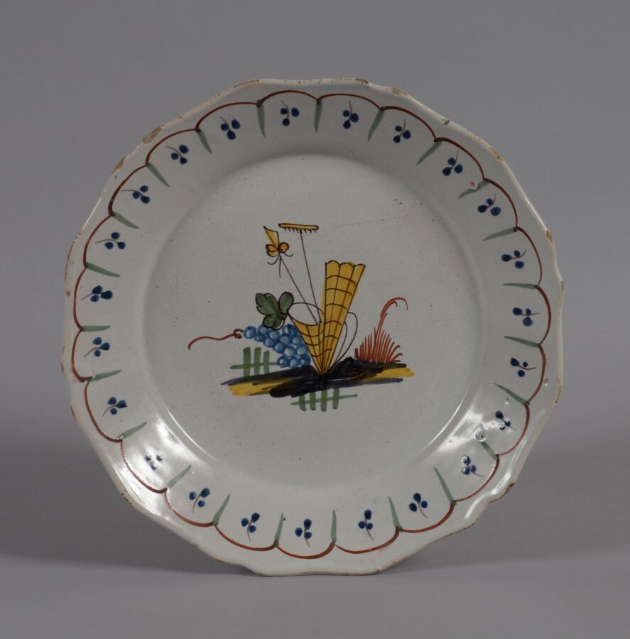 Null ǞǞǞ
一个多色陶盘，上面装饰着一串葡萄和一个葡萄种植者的工具。
18世纪晚期
直径23厘米
BE，小碎片