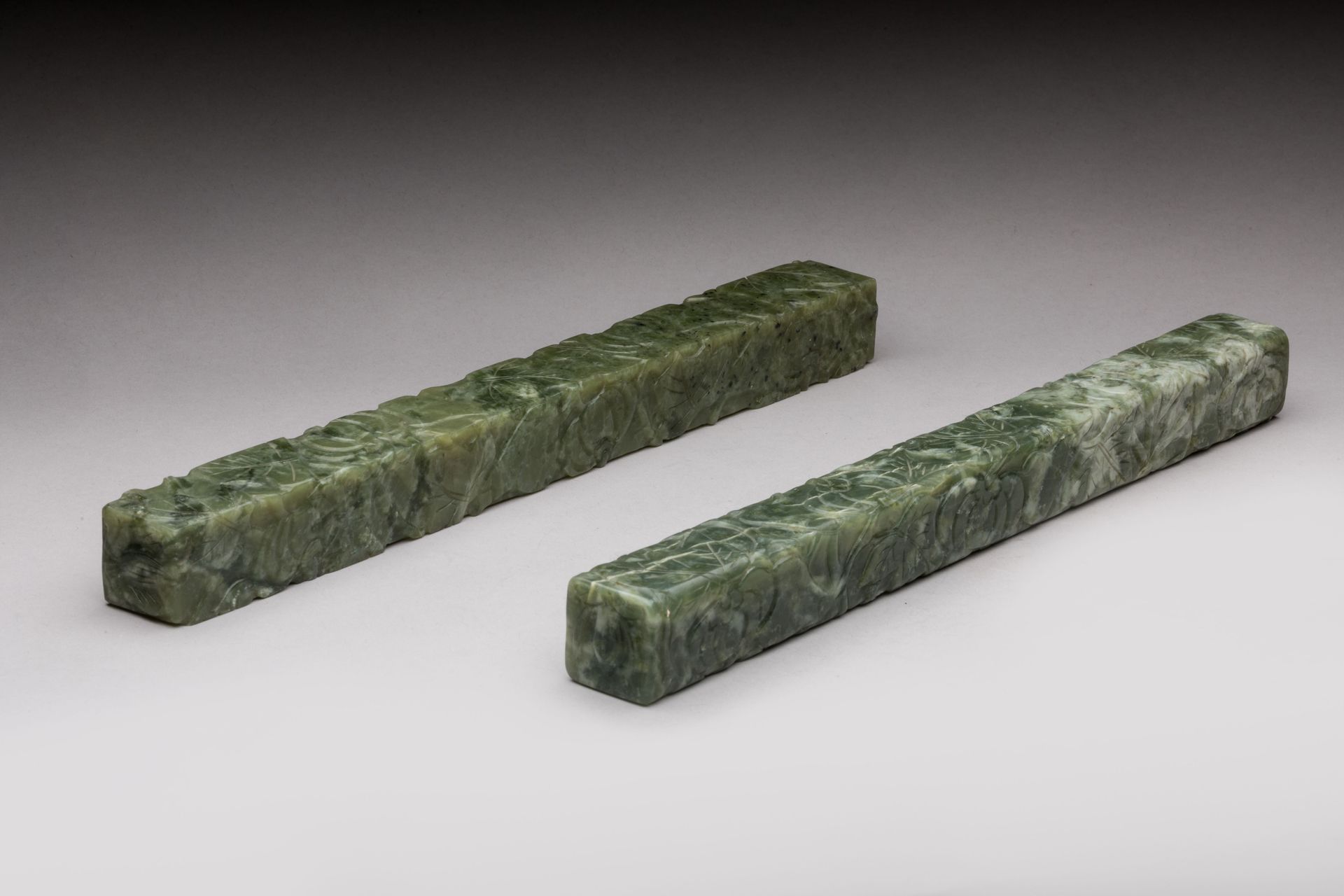 Null 
CHINA - 20th century 


Pair of green serpentine scroll weights carved wit&hellip;