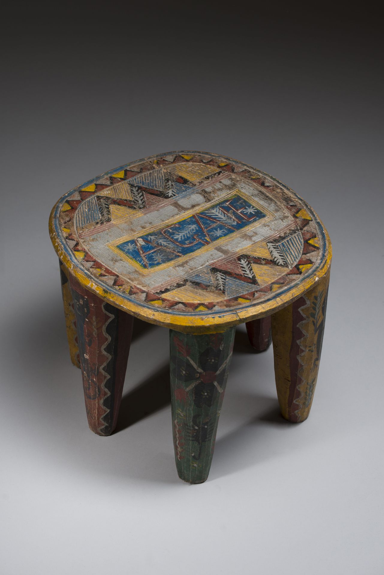 Null NUPE, NIGERIA. 
Polychrome wooden stool called "wedding stool" resting on s&hellip;