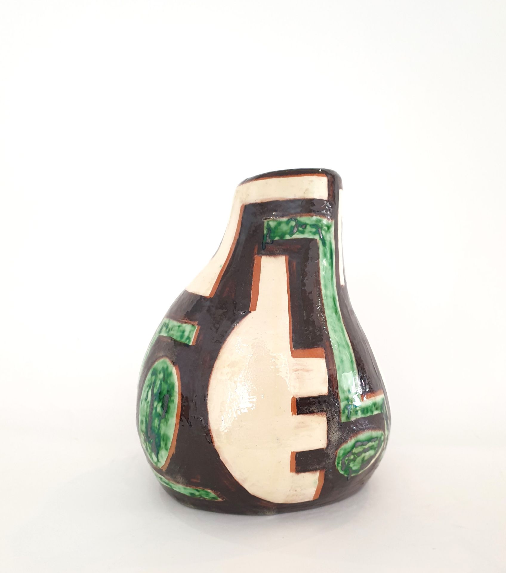 Null 20 世纪学院派，自由形式的釉陶花瓶，米色背景上有黑色、绿色和棕色的几何装饰。
H.24 厘米
(颈部有小的珐琅碎片）