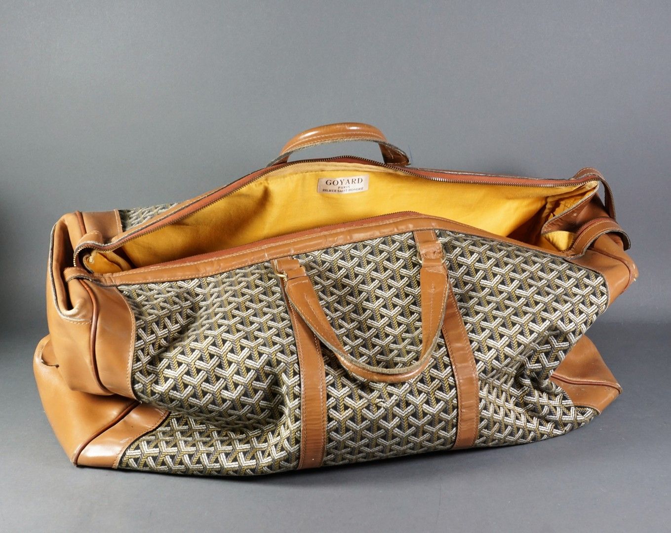 Maison GOYARD 
棕色布和皮革旅行袋，金色金属配件，布质内衬（磨损、污垢、撕裂）。