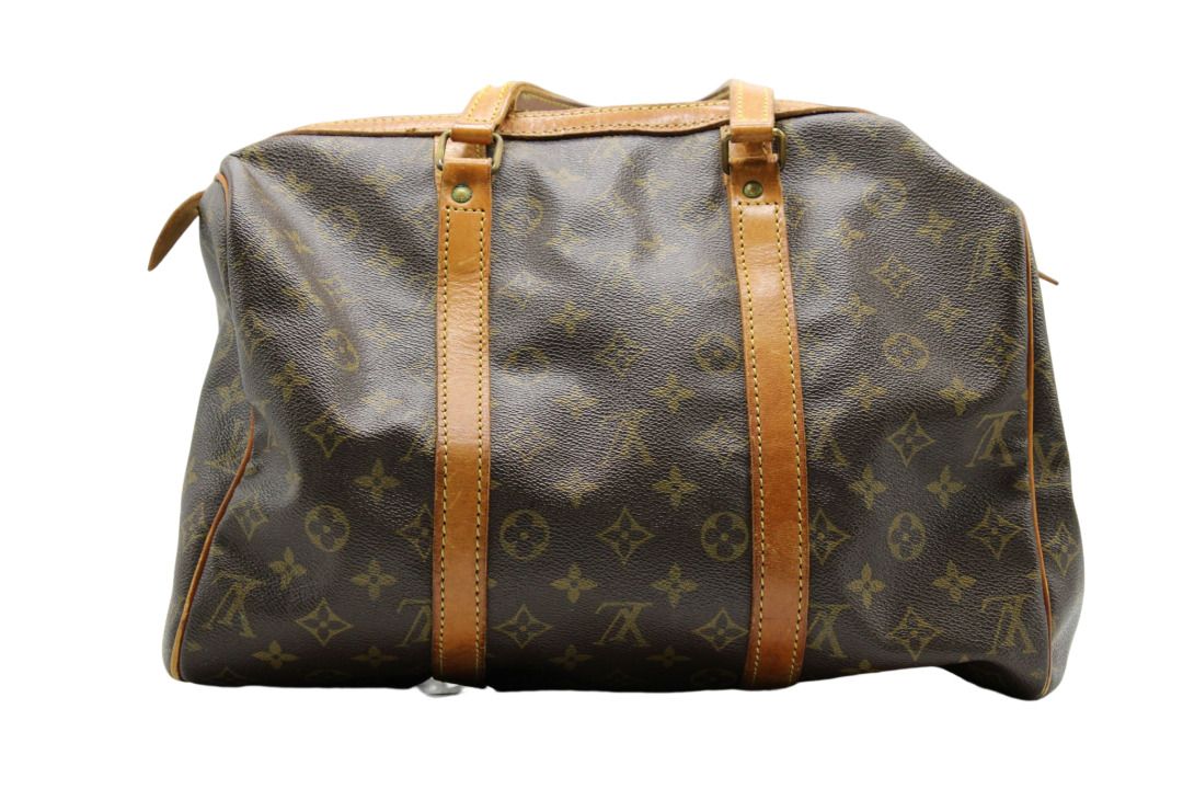 LOUIS VUITTON. Keepall bag in monogram canvas and natura…