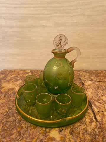 DAUM DAUM,

Glass liquor service with a mistletoe decoration on a green backgrou&hellip;