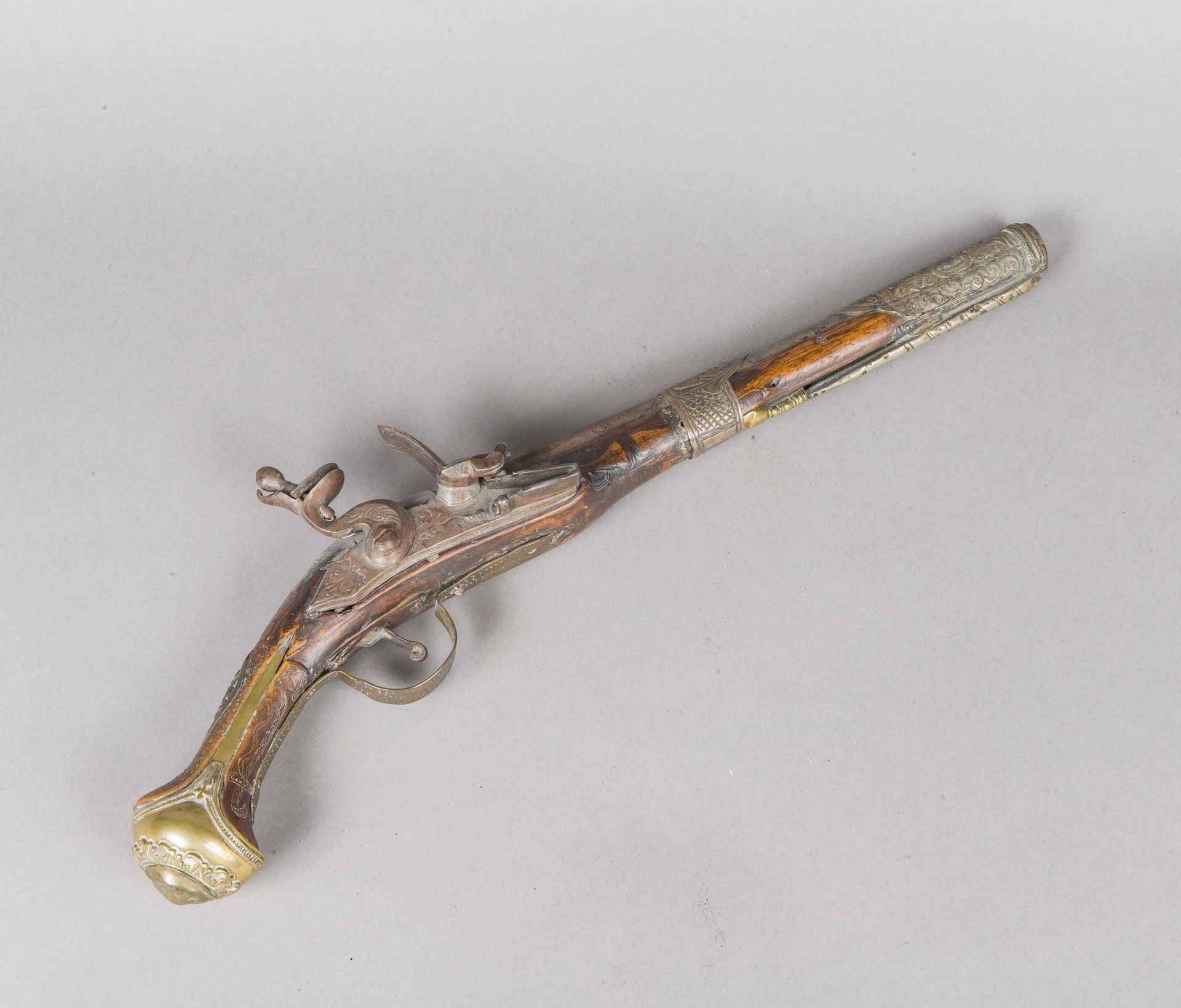Null Oriental flintlock pistol, swan-neck lock, wood and embossed brass stock. 
&hellip;