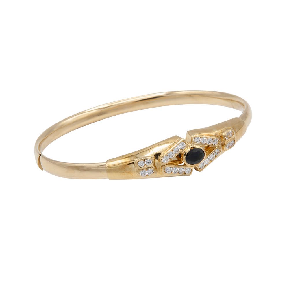 Null 18 kt gold rigid bracelet with blue stone and diamonds with side closure. D&hellip;