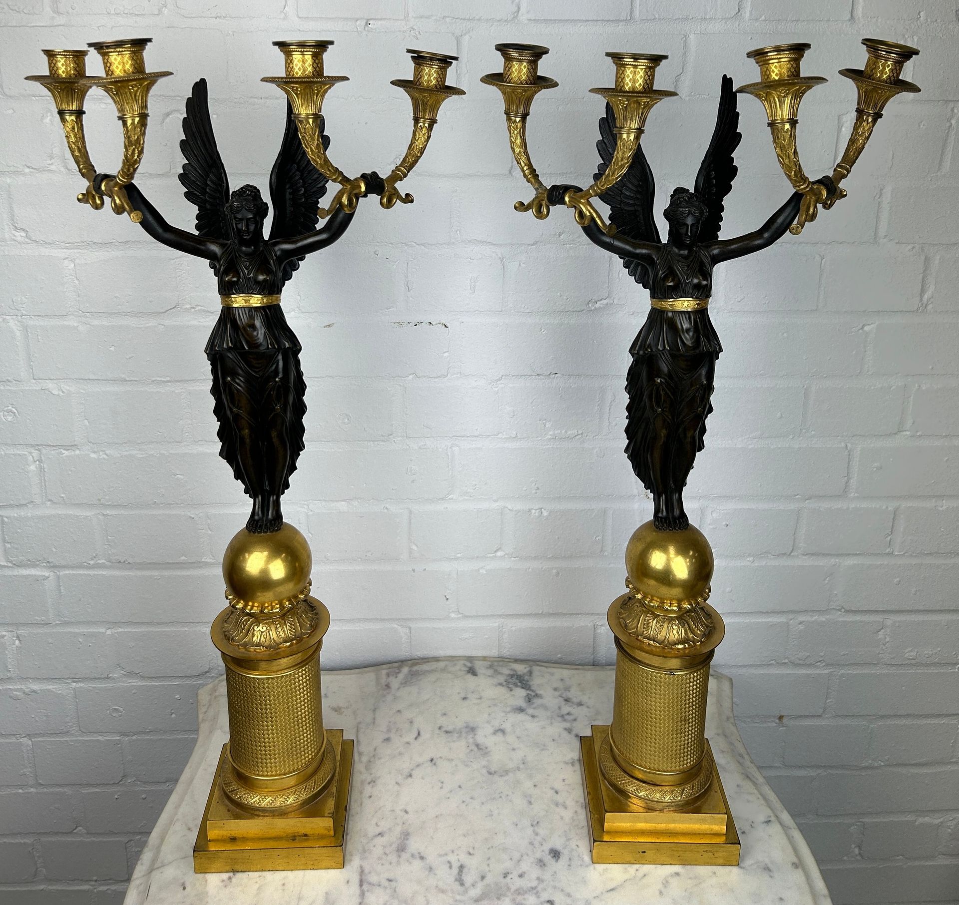 Null 一对 20 世纪早期法国帝国设计风格的镀金青铜四灯烛台，采用皮埃尔-菲利普-托米尔（1751-1843 年，法国人）的设计风格

每个烛台上都有一个寓&hellip;