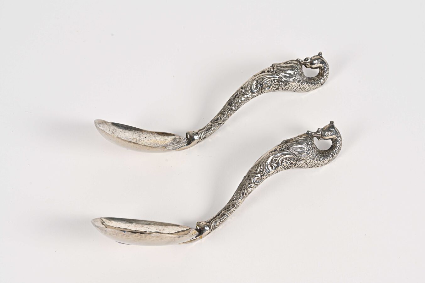 Null Two silver plated peacock serving spoons

Far East, 20th century BL