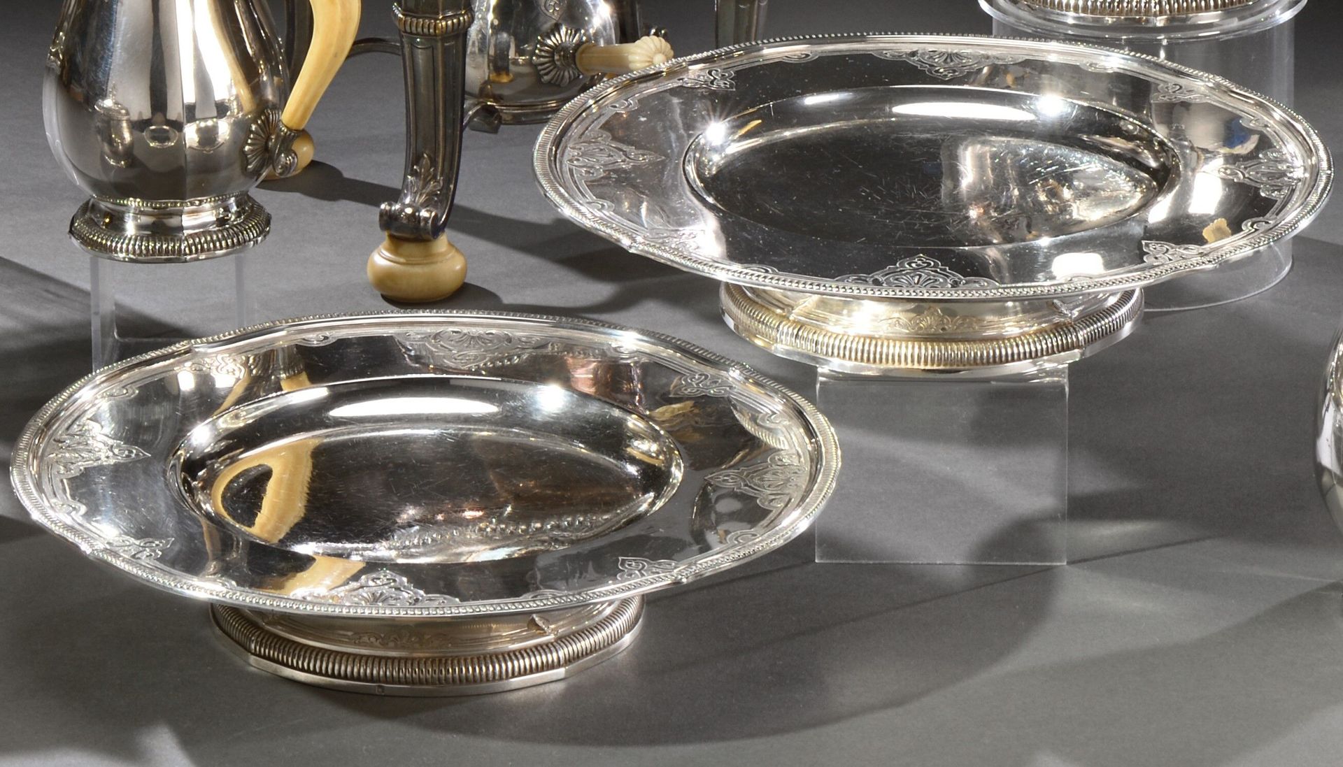 Null Pair of silver display stands on a pedestal, the circular tray with slight &hellip;