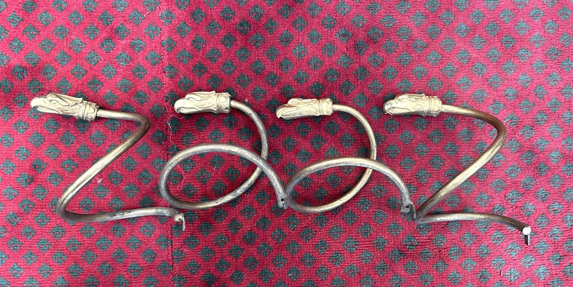 Null Suite of four twisted brass clasps, decorated with eagle heads.

Italian wo&hellip;