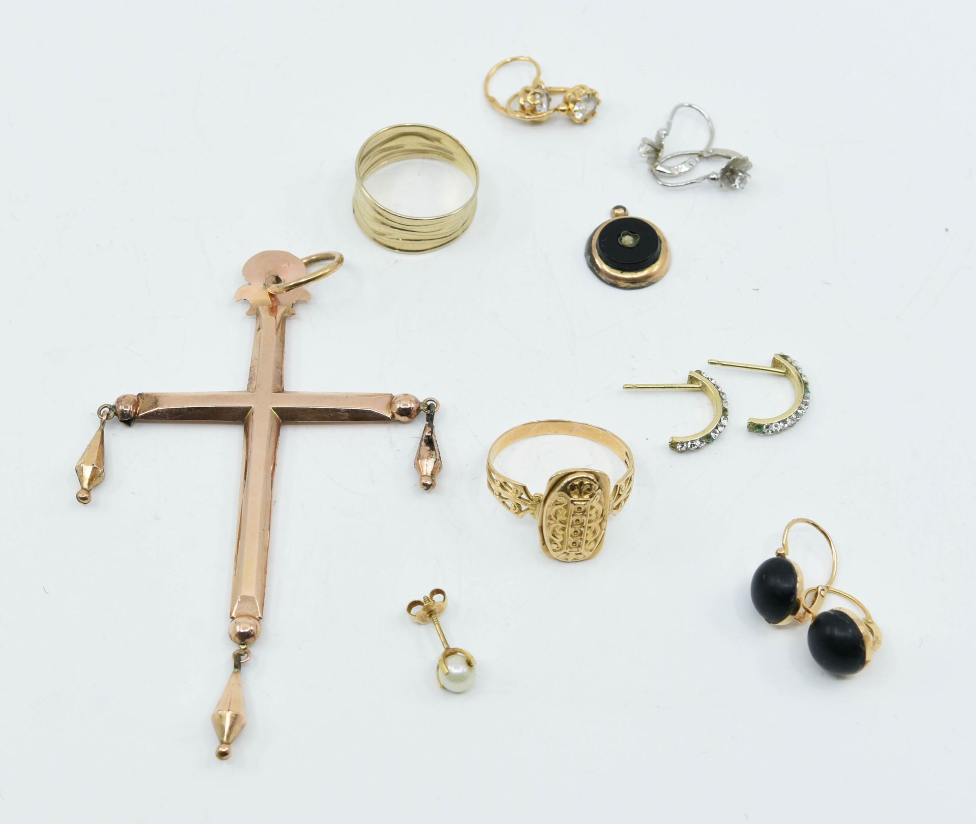 Null 18K（750°/°）金拍品包括：三对带水钻（缺拇指）、仿钻石、黑色半球形的耳环和一个带珍珠的耳环。 
我们附上一个18K（750°/°）玫瑰金十字架&hellip;