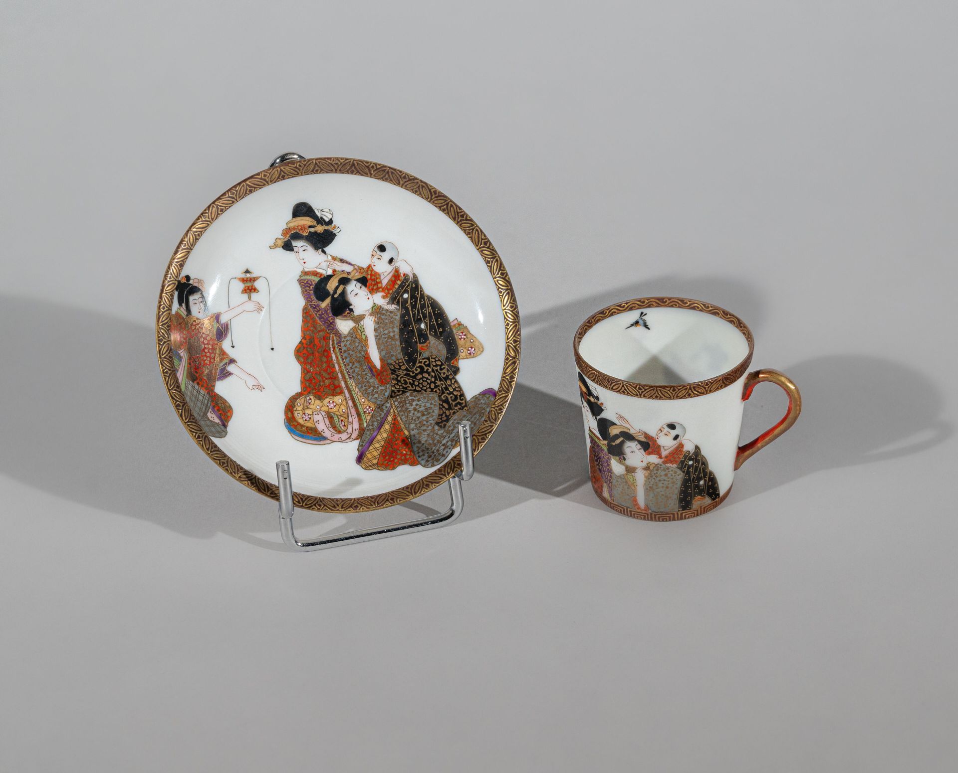 Null 小珐琅瓷杯和碟，日本，明治时期（1868-1912 年） 
带有妇女和儿童的珐琅装饰，边缘有精美的楣饰，杯中有一只鸟，有 "Wataya sei"（杯&hellip;