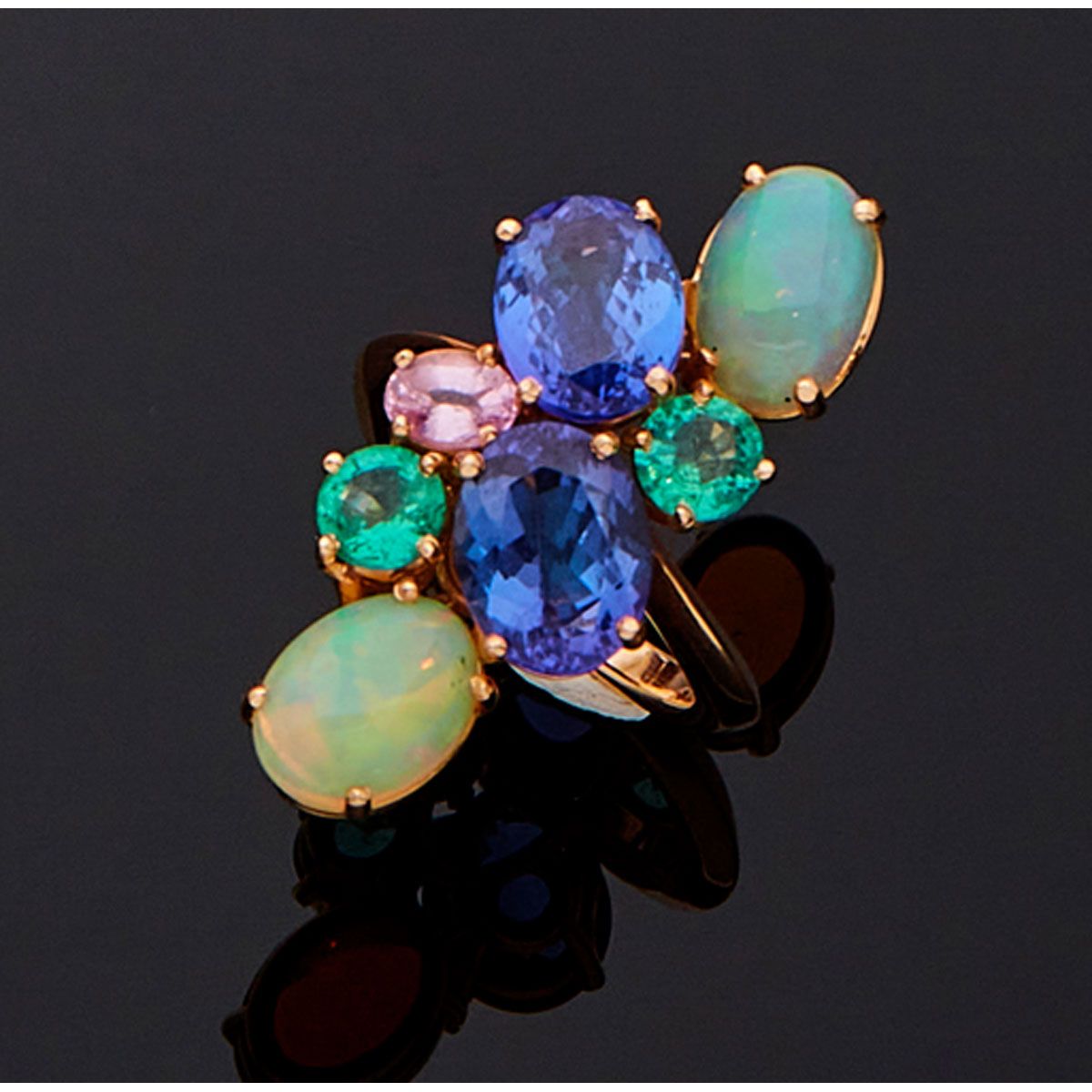 Null 18K玫瑰金戒指，镶有两颗坦桑石、两颗凸圆形切割蛋白石、两颗绿宝石和一颗粉色蓝宝石。法国的工作。

B.P. 12,2g。- TDD 54