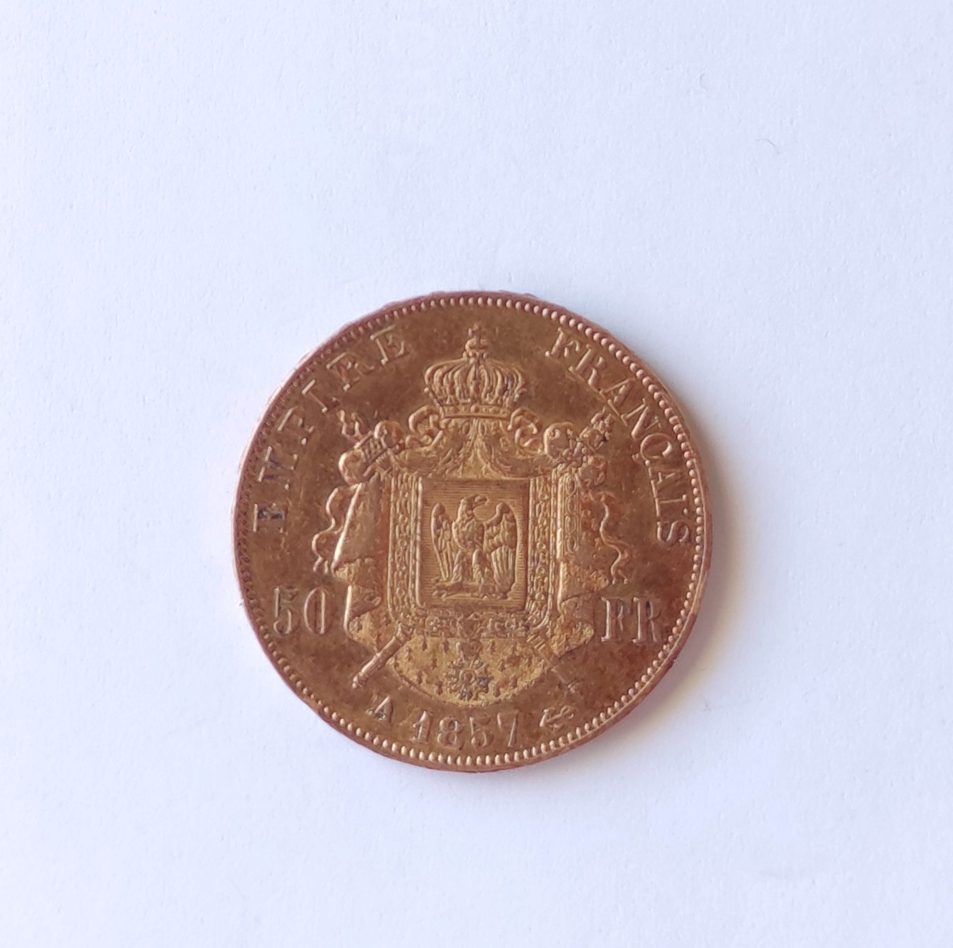 Null 
一块50法郎的黄金拿破仑三世，光头，A 1857重量：16.1克。
费用：价格的10%。