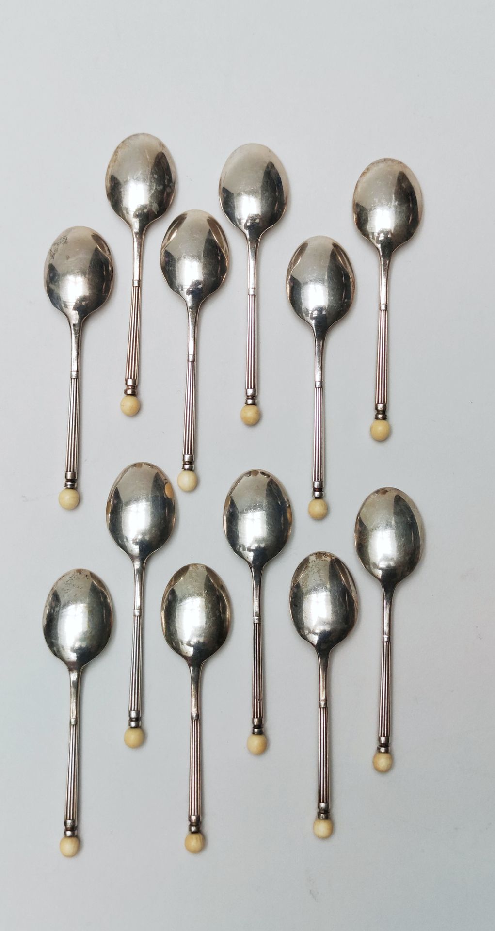 Null 
12 Cucchiai d'argento moka con design a sfera d'avorio, 20° secolo 




Pe&hellip;