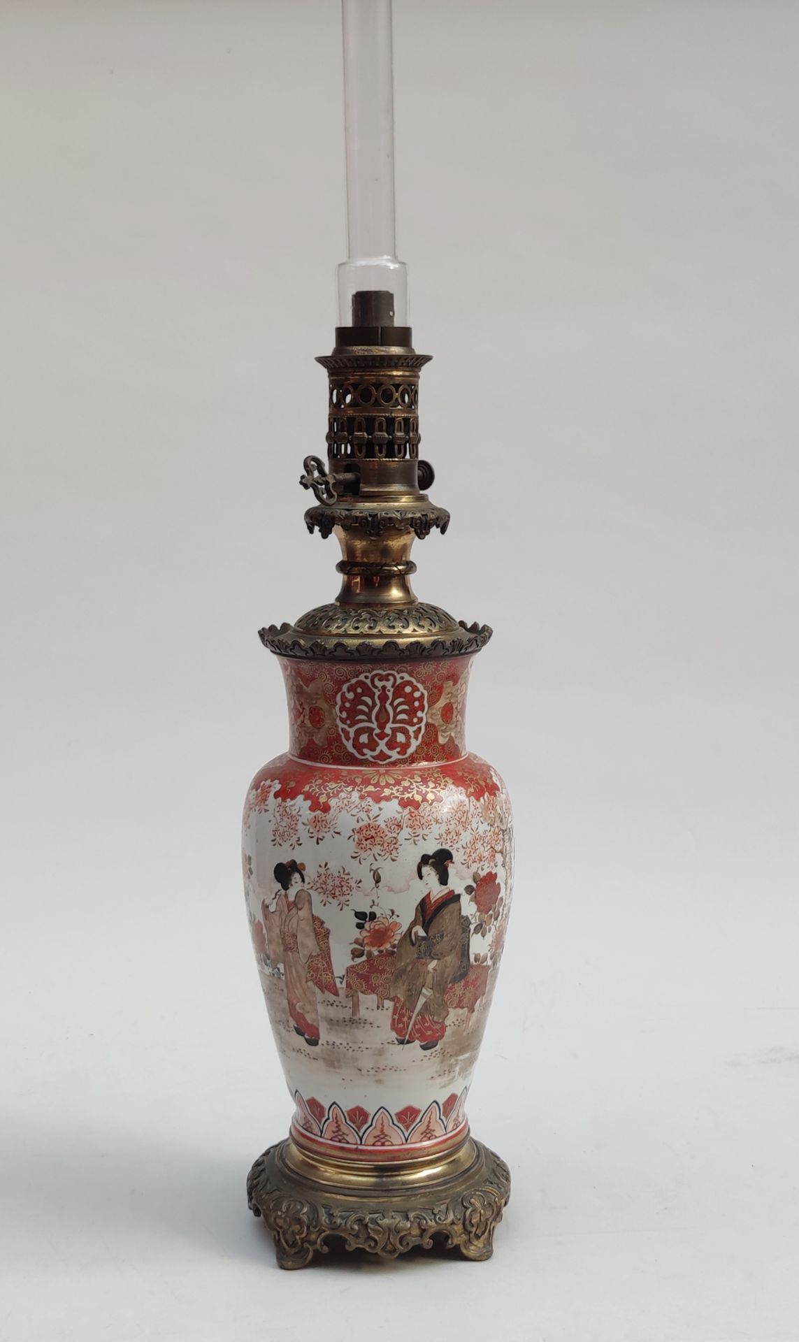 Null 
一对日本陶瓷油灯，釉面装饰为风景中的年轻女性，铜质安装，约1880/1900年