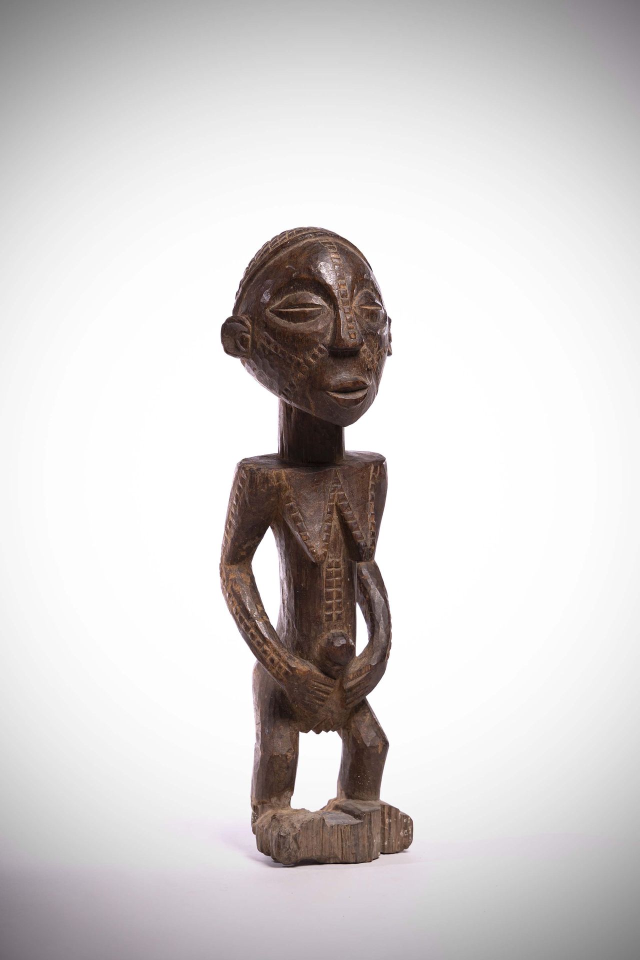 Null Tabwa

(DRC) Female statue with arms folded over the abdomen. 

She has sca&hellip;