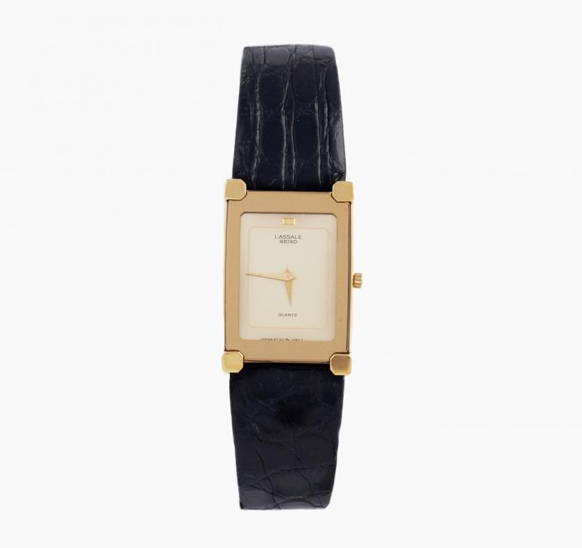 WATCH SEIKO LASSALE. QUARTZ. STEEL AND LEATHER Made in steel. Japanese quartz  movement. Rectangular case of 24 x 18 mm. Golden dial signed LASSALE SEIKO,  without numbering. Original leather strap. Number: 6730 -