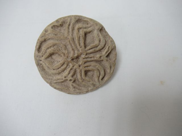 Null 米色赤土的面包标记，有叶子的装饰。以其抓紧的榫头。罗马时期。7厘米

购买阿尔勒，Golz-Artles，2002年12月15日