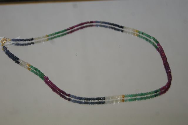 Null 项链，由红宝石、蓝宝石和绿宝石珠子组成。18K金表扣。长度：44厘米（开放）。