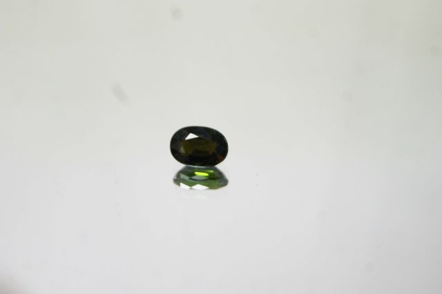 Null Dark honey tourmaline of oval size on paper. 

Weight: 1.44 carats approx.