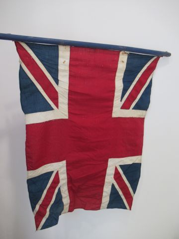 Null United Kingdom flag in wood and fabric. Broken handle, holes and stains.