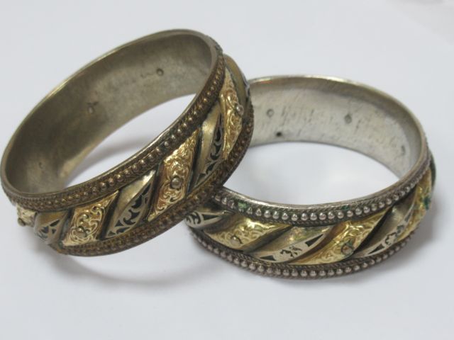 Null ASIA (?) Pair of bracelets in gold and silver plated metal.