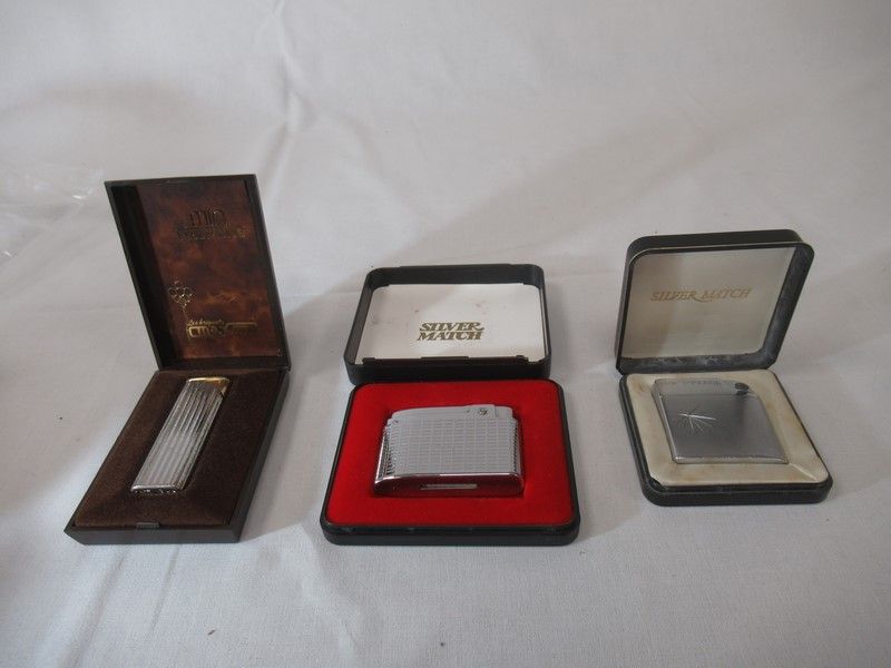 Null Set of three silver-plated lighters, in their cases