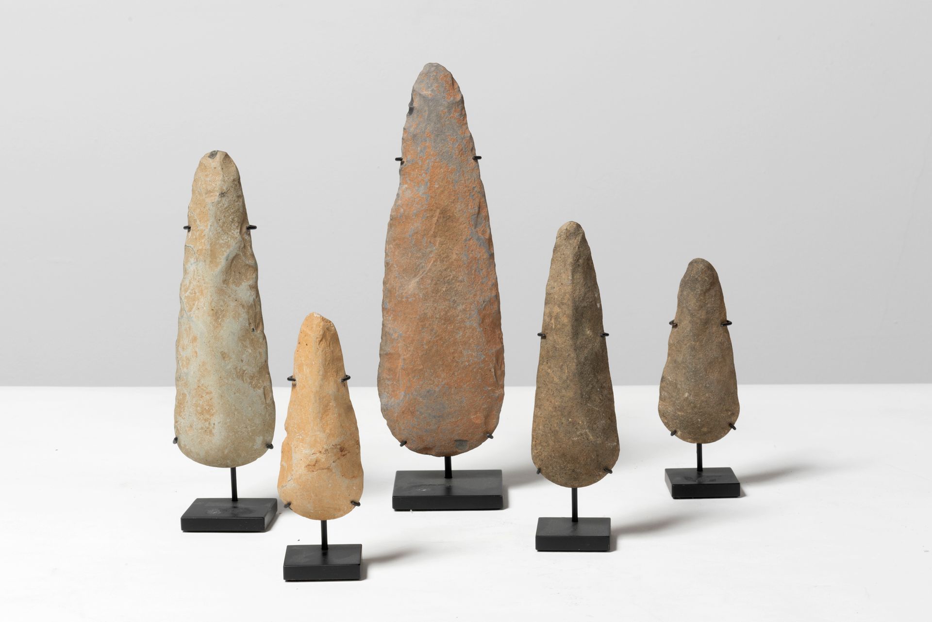 Null CURIOSITY CABINET Set Composed of five Neolithic axes mounted on a base.