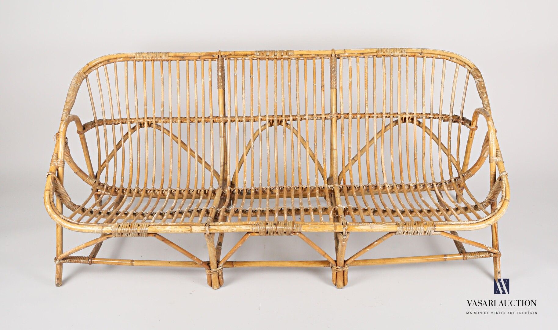 Null Rattan sofa, basket back. It rests on eight feet joined by a strut. 

20th &hellip;